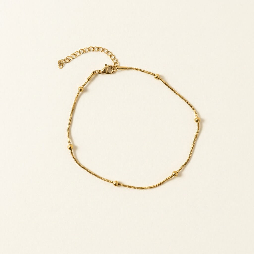 Chaîne de cheville serpent dorée avec boule
