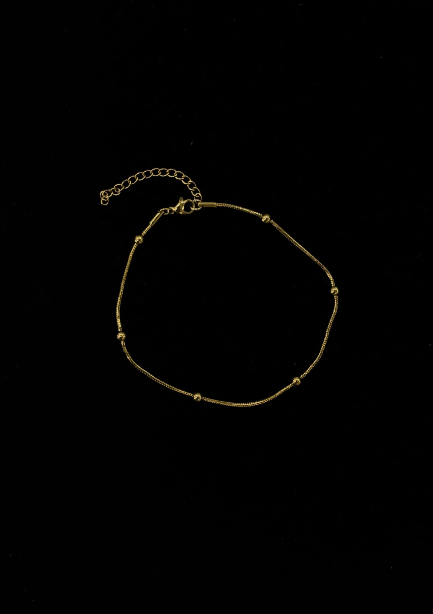 CHAINE DE CHEVILLE SERPENT DOREE AVEC BOULE
